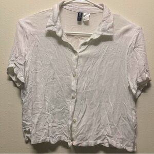White short sleeve button up shirt. Fits like small. Crop top.